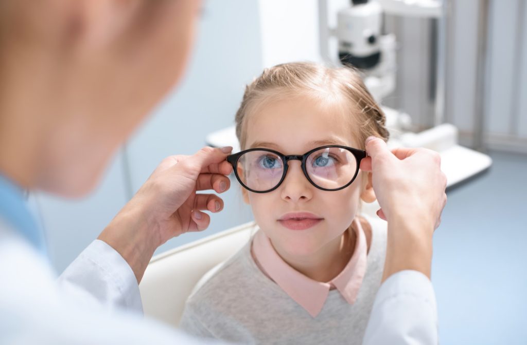 Child at the optometrist getting their glasses fitted properly