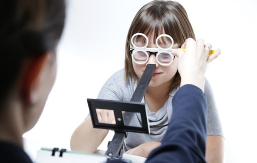 A young girl performing vision therapy to improve the quality and efficiency of her vision