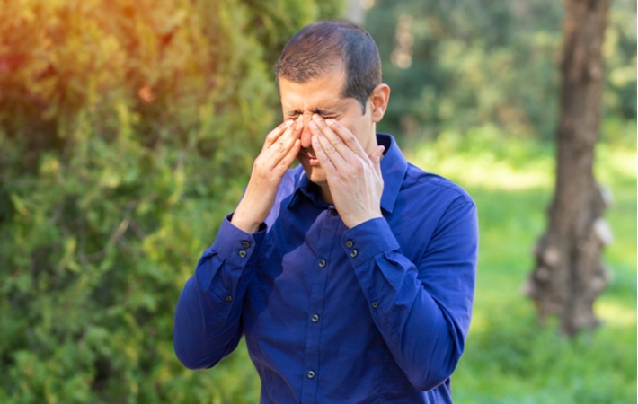 A man suffering from dry eye due to his allergies