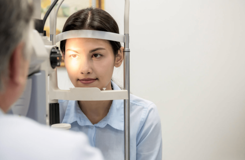A male optician is using a sit lamp in examining the eye of a female patient.  It is a key tool in determining the health of your eyes and detecting eye disease