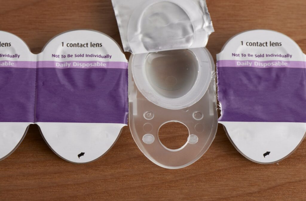 A pack of daily disposable contact lenses, the packaging is purple and white.