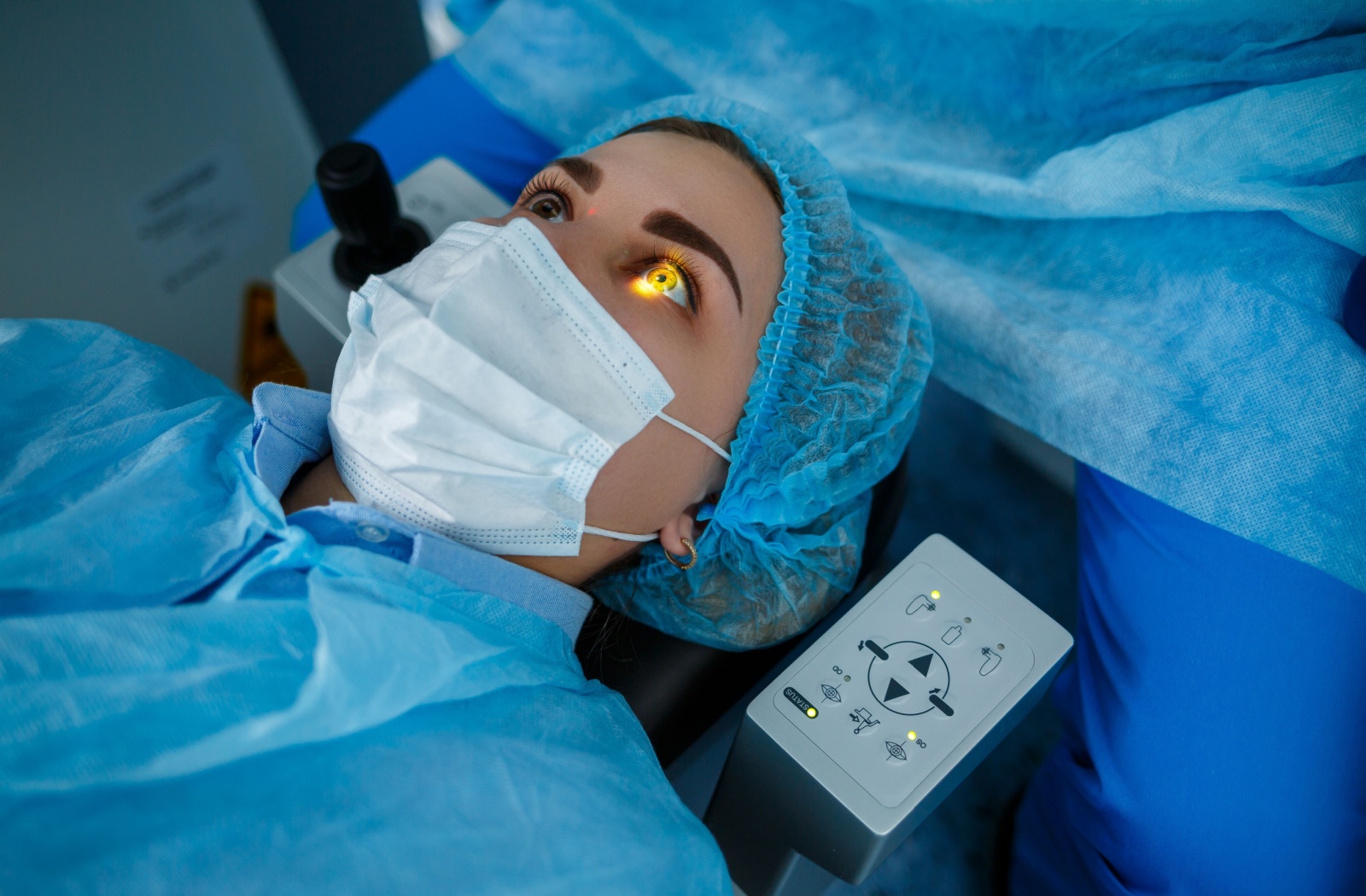 A patient on the surgical table, prepped to undergo LASIK surgery.